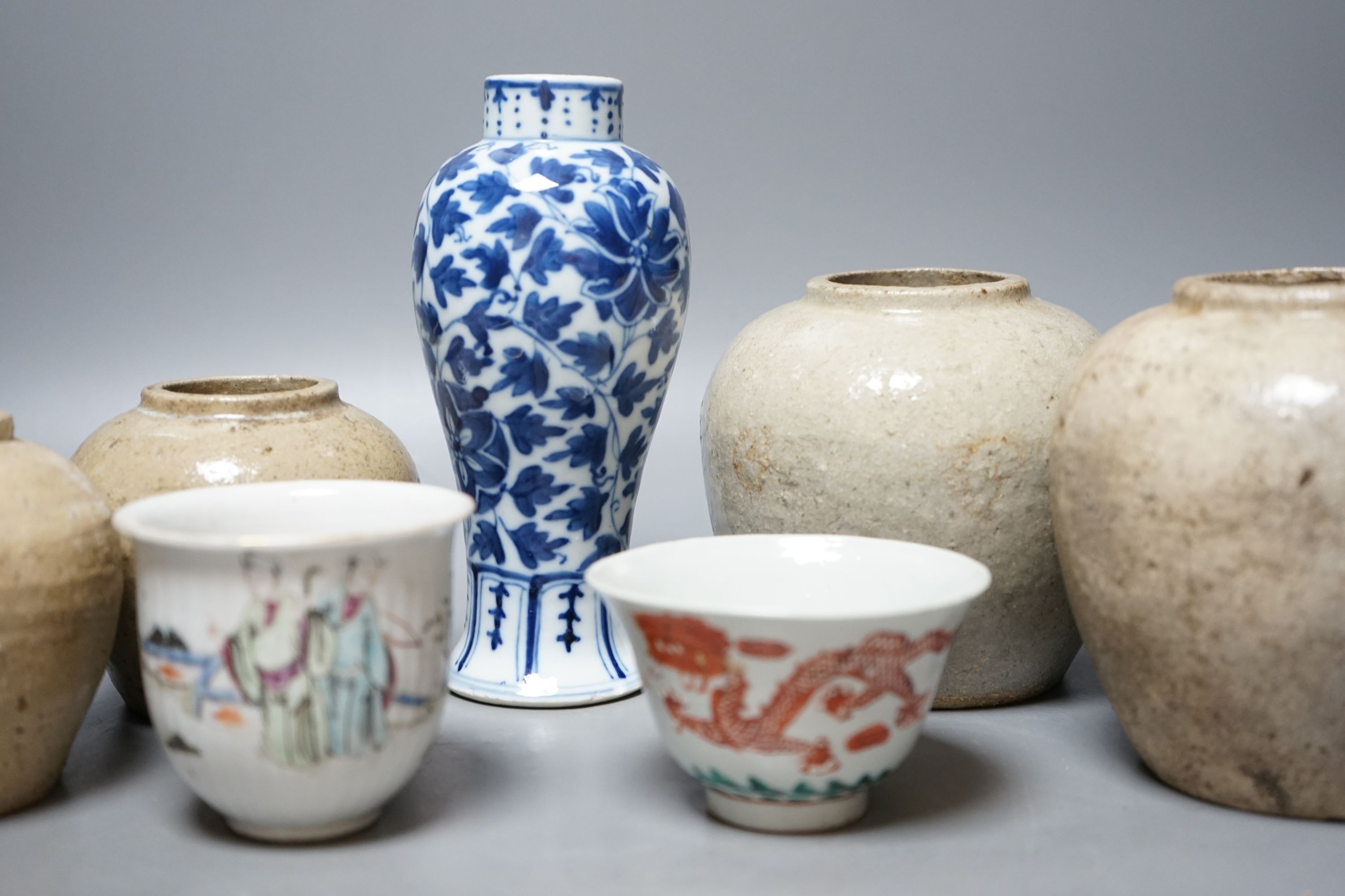 A Chinese blue and white vase, Xuande mark, c.1900, two late 19th Century Chinese cups and four Chinese provincial earthenware jars 19cm